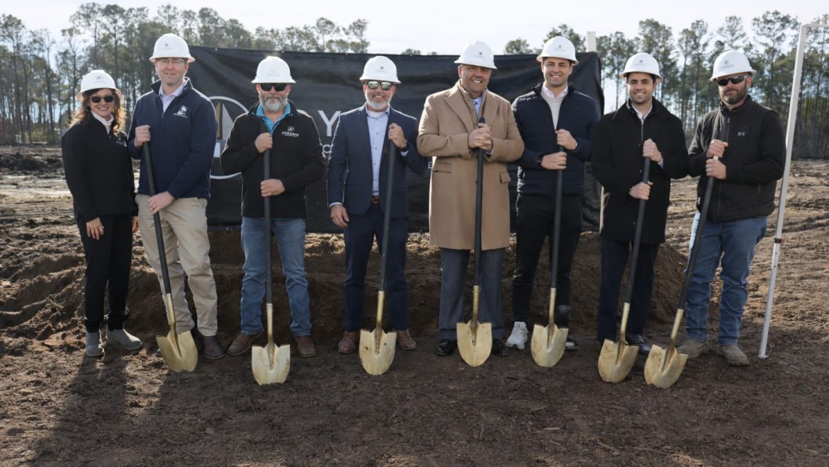 Members of the Pyramid team standing with the owners, each with a golden shovel, breaking ground at the site of the new dealership